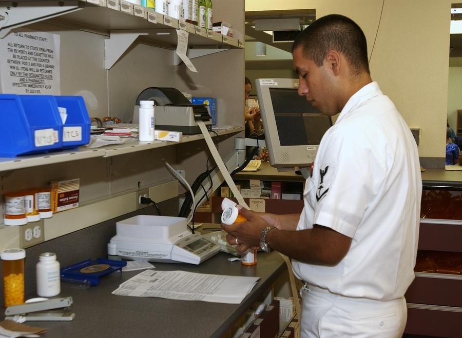 Archive: pharmacist labeling a prescription, National Naval Medical Center Bethesda, 19 Aug 2003. Not a Walmart pharmacy, pharmacist, or trademark.